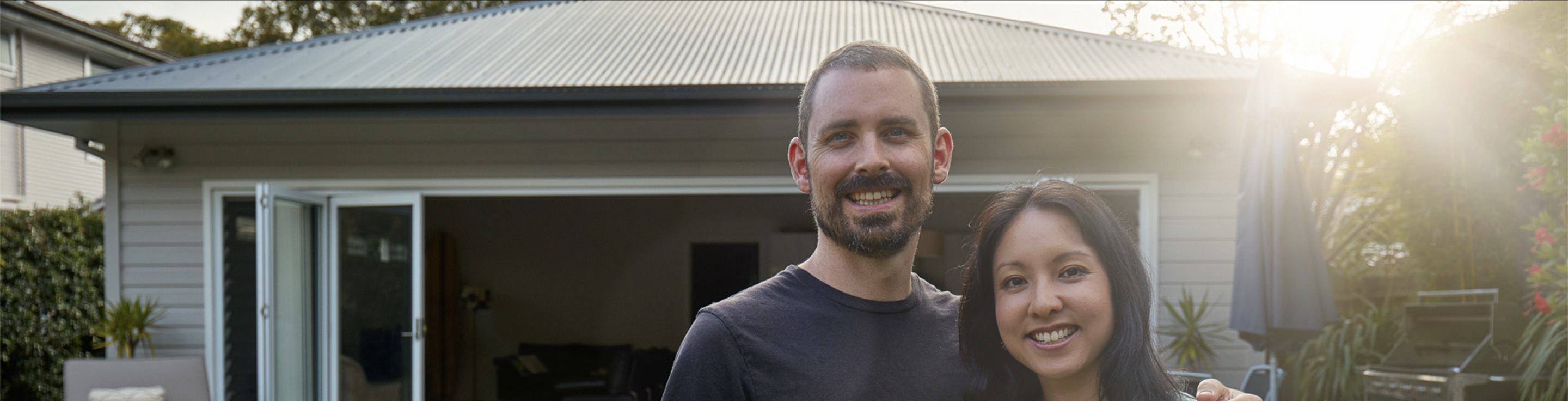 Homeowner couple outside of their house